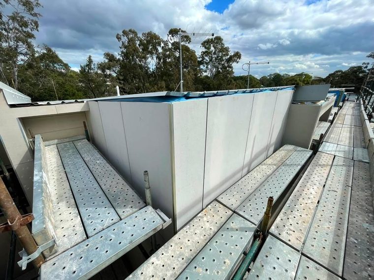 New external wall sheeted and finished, with scaffold access still in place